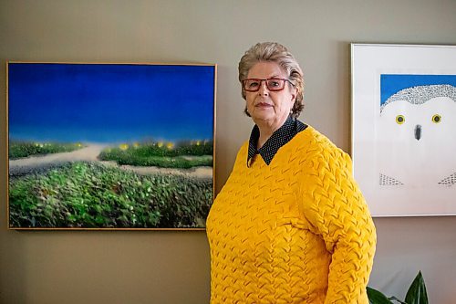 Daniel Crump / Winnipeg Free Press. Susan Thompson, former Winnipeg mayor during the Flood of the Century in 1997, stands by a painting of the Red River she purchased from local artist Aliana Au. April 9, 2022.