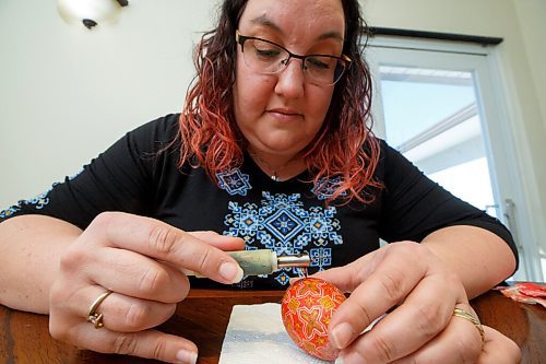 MIKE DEAL / WINNIPEG FREE PRESS
Tracy puts the final layer of beeswax on a pysanka.
Tracy Rossier has been making and selling Ukrainian pysanky eggs for years; her Instagram bio puts it succinctly, "Manitoba Ukrainian egg artist. Saving the world one pysanka at a time."
See Dave Sanderson story
220408 - Friday, April 08, 2022.