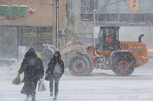 MIKE DEAL / WINNIPEG FREE PRESS
Pedestrians cross Portage Avenue during heavy snowfall while front end loaders clear snow Wednesday morning. 
220413 - Wednesday, April 13, 2022.