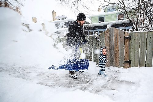 MIKE DEAL / WINNIPEG FREE PRESS
Orion Koham, 1, helps his dad, Andrew, shovel the sidewalk in front of there house in Fort Rouge, Thursday morning. 
220414 - Thursday, April 14, 2022