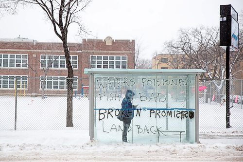 MIKE DEAL / WINNIPEG FREE PRESS
A person waits in a graffitied bus stop on Maryland Street, Thursday morning. 
220414 - Thursday, April 14, 2022.