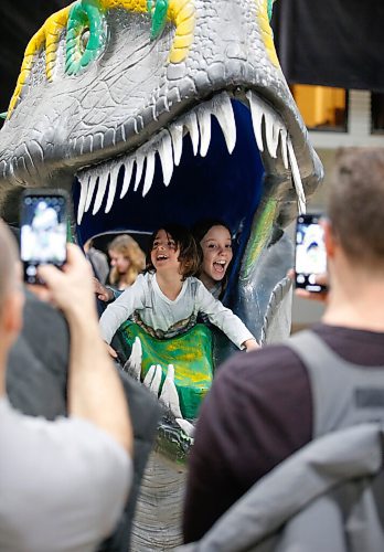 JOHN WOODS / WINNIPEG FREE PRESS
Thomas Renzelli, left, and Isabella Krstic pop out of a dinosaur head as their dads Frank Renzelli and Alek Krstic photograph them during Jurassic Quest at the Convention Centre Friday, April 15, 2022. 

Re: searle