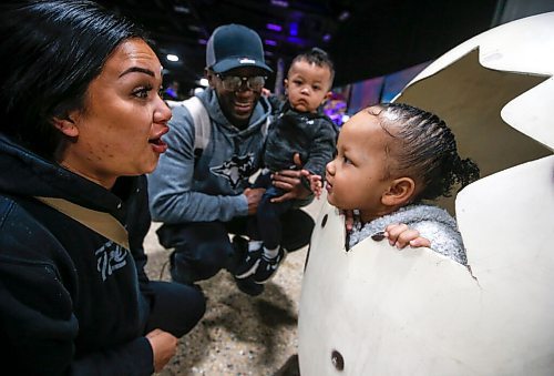 JOHN WOODS / WINNIPEG FREE PRESS
Dezhere Policarpio and Serge Uwimana play with their daughter as she pops her head out of a dinosaur egg during Jurassic Quest at the Convention Centre Friday, April 15, 2022. 

Re: searle