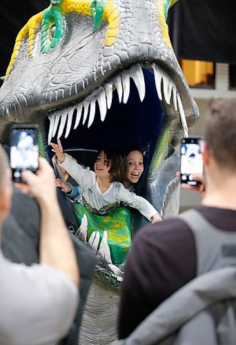 JOHN WOODS / WINNIPEG FREE PRESS
Thomas Renzelli, left, and Isabella Krstic pop out of a dinosaur head as their dads Frank Renzelli and Alek Krstic photograph them during Jurassic Quest at the Convention Centre Friday, April 15, 2022. 

Re: searle