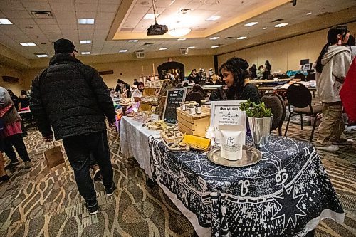 Daniel Crump / Winnipeg Free Press. Brittany McLeod of Woodland Spirits sits at her booth at the ZIIGWAN (Spring) Indigenous Arts Market & Tradeshow at Canad Inns Polo Park in Winnipeg. April 16, 2022.