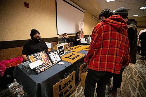 Daniel Crump / Winnipeg Free Press. Pheonix Hourie and Sad Jonsa browse vendors at the ZIIGWAN (Spring) Indigenous Arts Market & Tradeshow at Canad Inns Polo Park in Winnipeg. April 16, 2022.