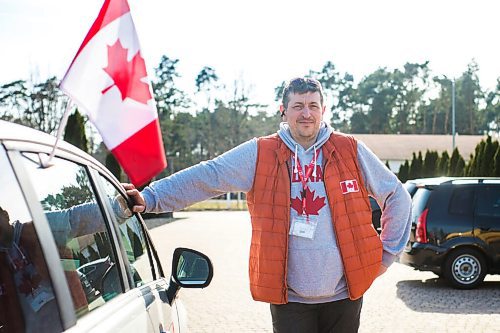 MIKAELA MACKENZIE / WINNIPEG FREE PRESS

Alexander Leontiev poses for a portrait with his car, which he has decorated with Canadian flags, in Wrzesnia on Tuesday, April 12, 2022. For Melissa story.
Winnipeg Free Press 2022.