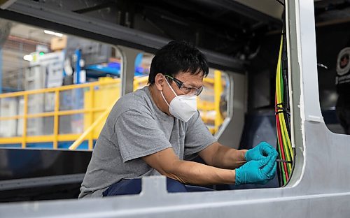 JESSICA LEE / WINNIPEG FREE PRESS

Nick Almonde, a worker at New Flyer Industries, is photographed working on a bus on April 20, 2022 at the warehouse. Moments before, Minister Dan Vandal announced a $2.9 million investment in the Vehicle Technology Centre.


Reporter: Martin