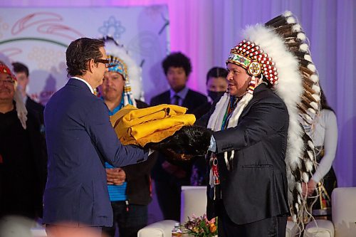 MIKE DEAL / WINNIPEG FREE PRESS
Southern Chiefs Organization Grand Chief, Jerry Daniels gives HBC Governor, Richard Baker two beaver pelts and two elk hides during the ceremony where the SCO took possession of the downtown Winnipeg, Hudsons Bay Co. building from the HBC.
The Southern Chiefs' Organization took possession of the downtown Winnipeg, Hudsons Bay Co. building during a two-hour ceremony Friday morning, which was attended by Prime Minister Trudeau, Manitoba Premier Heather Stefanson, Southern Chiefs Organization Grand Chief, Jerry Daniels, HBC Governor, Richard Baker, Ahmed Hussen, Minister of Housing and Diversity and Inclusion, Patty Hajdu, Minister of Indigenous Services Canada, and Dan Vandal, Minister of Northern Affairs and Minister responsible for Prairies Economic Development Canada. The vacant six-storey building, which opened in 1926 was closed in November 2020.
220422 - Friday, April 22, 2022.