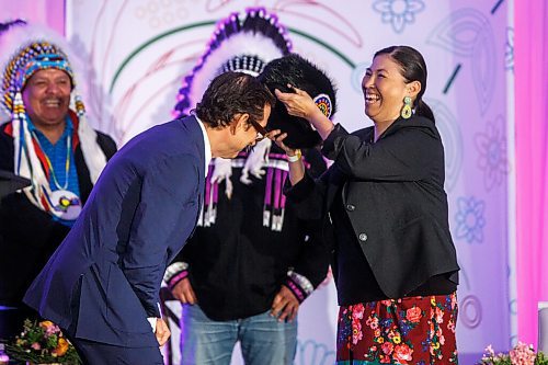 MIKE DEAL / WINNIPEG FREE PRESS
HBC Governor, Richard Baker accepts the gift of a beaver hat from traditional beader Joanne Soldier during the ceremony.
The Southern Chiefs Organization took posession of the downtown Winnipeg, Hudsons Bay Co. building during a two-hour ceremony Friday morning, which was attended by Prime Minister Trudeau, Manitoba Premier Heather Stefanson, Southern Chiefs Organization Grand Chief, Jerry Daniels, HBC Governor, Richard Baker, Ahmed Hussen, Minister of Housing and Diversity and Inclusion, Patty Hajdu, Minister of Indigenous Services Canada, and Dan Vandal, Minister of Northern Affairs and Minister responsible for Prairies Economic Development Canada. The vacant six-storey building, which opened in 1926 was closed in November 2020.
220422 - Friday, April 22, 2022.