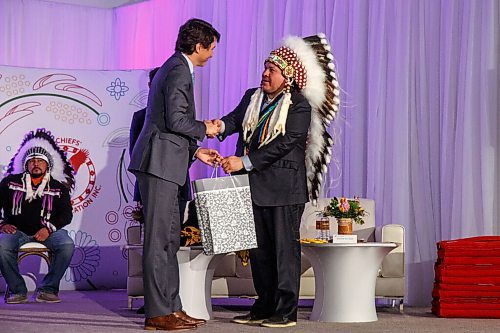 MIKE DEAL / WINNIPEG FREE PRESS
Prime Minister Justin Trudeau gives a gift to Southern Chiefs Organization Grand Chief, Jerry Daniels during the ceremony.
The Southern Chiefs Organization took posession of the downtown Winnipeg, Hudsons Bay Co. building during a two-hour ceremony Friday morning, which was attended by Prime Minister Trudeau, Manitoba Premier Heather Stefanson, Southern Chiefs Organization Grand Chief, Jerry Daniels, HBC Governor, Richard Baker, Ahmed Hussen, Minister of Housing and Diversity and Inclusion, Patty Hajdu, Minister of Indigenous Services Canada, and Dan Vandal, Minister of Northern Affairs and Minister responsible for Prairies Economic Development Canada. The vacant six-storey building, which opened in 1926 was closed in November 2020.
220422 - Friday, April 22, 2022.