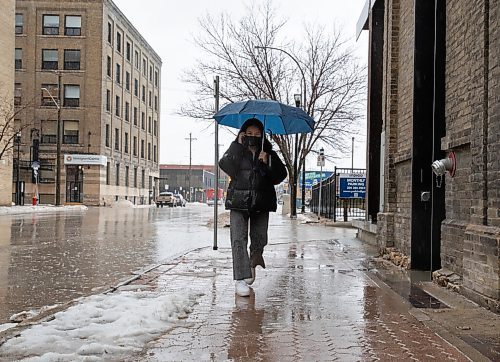 JESSICA LEE / WINNIPEG FREE PRESS

Hsar Hsar walks on Bannatyne Ave. on April 22, 2022 during the rain.