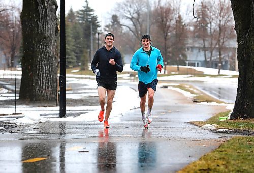 RUTH BONNEVILLE / WINNIPEG FREE PRESS

Weather standup

Two runners don't let the wet, cold spring weather stop them from running at a very high pace along Wellington Cr. Friday. 

(Was not able to get their names)
April 22nd,  2022
