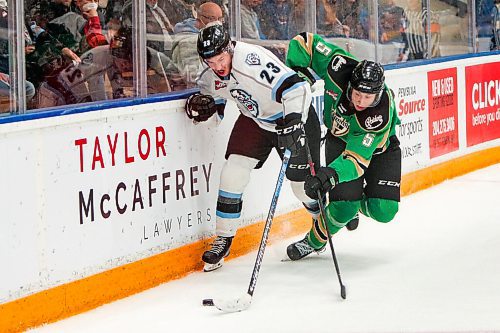 Daniel Crump / Winnipeg Free Press. Winnipeg Ice Jakin Smallwood (23) holds off a Prince Albert player long the boards as the Winnipeg Ice take on the visiting Prince Albert Raiders in game one, round one, of the WHL playoffs, at Wayne Fleming Arena in Winnipeg. April 22, 2022.