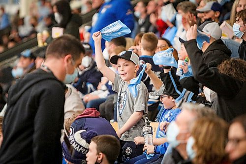 Daniel Crump / Winnipeg Free Press. A young Ice fan cheers as the Winnipeg Ice take on the visiting Prince Albert Raiders in game one, round one, of the WHL playoffs, at Wayne Fleming Arena in Winnipeg. April 22, 2022.