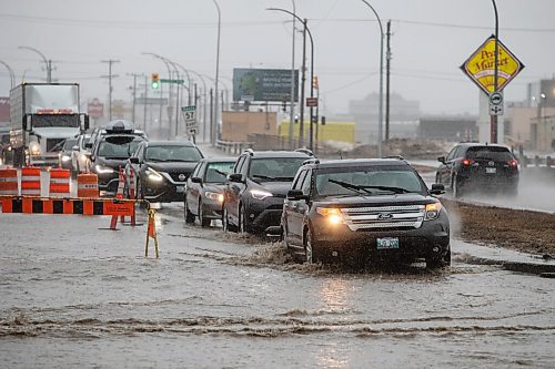 Daniel Crump / Winnipeg Free Press. Motorists navigate deep water and a large hidden pothole on route 90 just north of Dublin Avenue in Winnipeg. April 23, 2022.