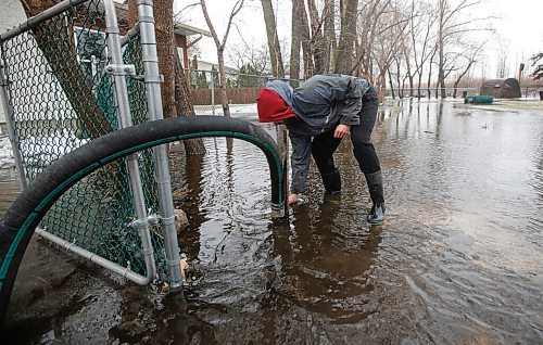 JOHN WOODS / WINNIPEG FREE PRESS
Brett Hanslit check a pump at his home after a railway ditch overflowed its banks and flooded their property on Rizzuto Bay Sunday, April 24, 2022. 

Re: Macintosh