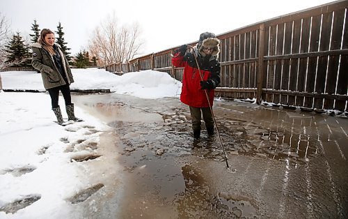 JOHN WOODS / WINNIPEG FREE PRESS
Nicole Vechina and her son Noah, 10, break up some ice in their flooded yard in Headingley Monday, April 25, 2022. 

Re: kitching