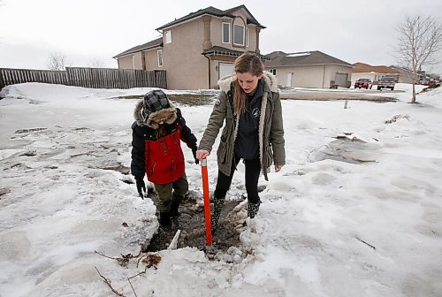 JOHN WOODS / WINNIPEG FREE PRESS
Nicole Vechina and her son Noah, 10, check a drain in their yard which was flooded yesterday in Headingley Monday, April 25, 2022. 

Re: kitching
