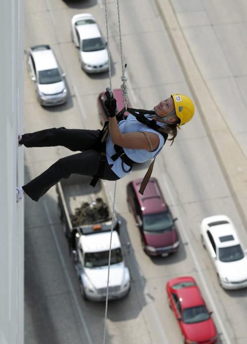 MIKE.DEAL@FREEPRESS.MB.CA 100819 - Thursday, August 19, 2010 -  Heather Powney rappels down the RBC building in downtown Winnipeg during the 2010 Easter Seals Drop Zone Event. Each participant was required to raise a minimum of $1,500 for Easter Seals for the event. MIKE DEAL / WINNIPEG FREE PRESS