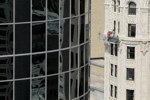 MIKE.DEAL@FREEPRESS.MB.CA 100819 - Thursday, August 19, 2010 -  A crew works on repairing a window of the old National Bank building while the Can West Global Place building looms to the left. MIKE DEAL / WINNIPEG FREE PRESS