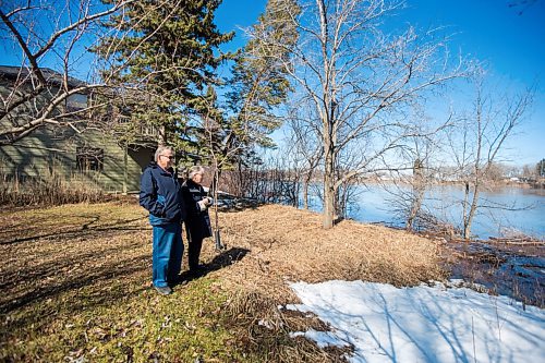 MIKAELA MACKENZIE / WINNIPEG FREE PRESS

Bob and Judy Roehle, St. Norbert homeowners who shared their memories of the 1997 flood, pose for a portrait by the river (and the house that nearly floated away) on their property on Tuesday, April 26, 2022.
Winnipeg Free Press 2022.