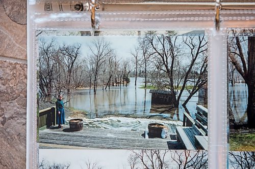 MIKAELA MACKENZIE / WINNIPEG FREE PRESS

A photo album with Bob and Judy Roehle's memories of the 1997 flood (here, Judy stands on the back porch of the main house with the flooded yard behind) in St. Norbert on Tuesday, April 26, 2022.
Winnipeg Free Press 2022.