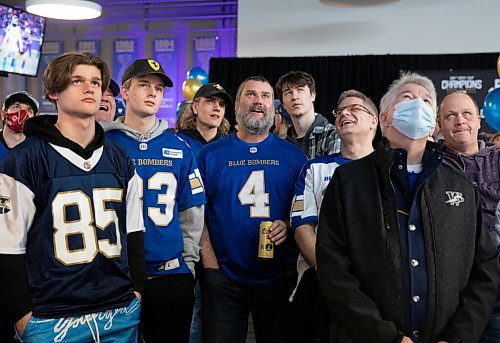 JESSICA LEE / WINNIPEG FREE PRESS

Blue Bombers fans (from left, front row) Logan Hargreaves, Seth Doyle, Brad Hargreaves, David Doyle and Denis Vincent watch a recap video of the Bombers wins at the Pinnacle Club at IG Field before the revealing of a new uniform on April 28, 2022.