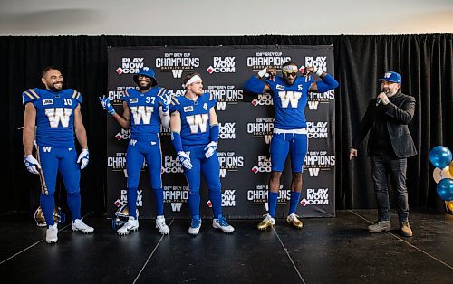 JESSICA LEE / WINNIPEG FREE PRESS

Blue Bombers players (from left) receiver Nic Demski, safety Brandon Alexander, linebacker Adam Bighill and defensive end Willie Jefferson show off new uniforms on April 28, 2022 at the Pinnacle Club at IG Field.
