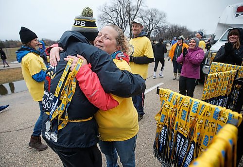 JOHN WOODS / WINNIPEG FREE PRESS
Marianna Dziver, oncology nurse and volunteer at the Winnipeg Police Service (WPS) Half Marathon gives a medal and a hug to on runner Jack Dubnicoff, 85, in Assiniboine Park Sunday, May 1, 2022. Proceeds go to the Canadian Cancer Society. When asked why he ran he replied, "I love to run, and I've got to keep going until I get around the corner"

Re: Searle