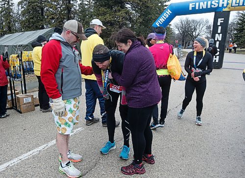 JOHN WOODS / WINNIPEG FREE PRESS
Jared Spier, who ran for wife Joanne Schiewe who died in 2015 of canecr, is comforted by friends as he finishes at the Winnipeg Police Service (WPS) Half Marathon in Assiniboine Park Sunday, May 1, 2022. Proceeds go to the Canadian Cancer Society.

Re: Searle