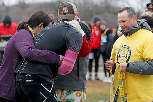 JOHN WOODS / WINNIPEG FREE PRESS
Jared Spier, who ran for wife Joanne Schiewe who died in 2015 of cancer, is comforted by friends as he finishes at the Winnipeg Police Service (WPS) Half Marathon in Assiniboine Park Sunday, May 1, 2022. Proceeds go to the Canadian Cancer Society.

Re: Searle