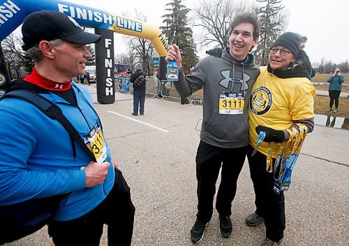 JOHN WOODS / WINNIPEG FREE PRESS
Kevin Kavitch, left, and his son Tyler are congratulated by friend Karen Timchuk as they finish the Winnipeg Police Service (WPS) Half Marathon in Assiniboine Park Sunday, May 1, 2022. Proceeds go to the Canadian Cancer Society.  The Kavithch relay team ran for their wife and mum Linda who died of cancer recently.

Re: Searle