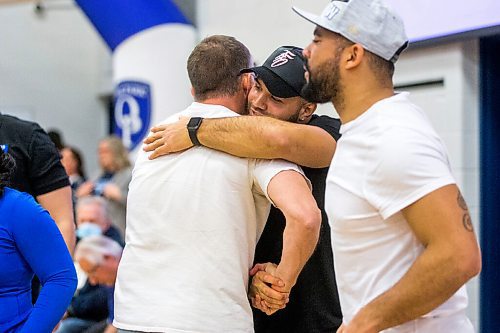 MIKAELA MACKENZIE / WINNIPEG FREE PRESS

Stu Nixon (retiring coach) hugs Brady Olivera during a visit to Oak Park School with the Grey Cup in Winnipeg on Monday, May 2, 2022. For Taylor Allen story.
Winnipeg Free Press 2022.