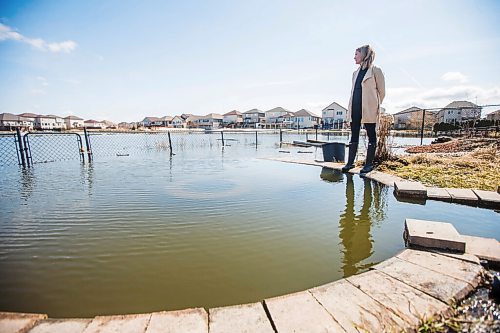 MIKAELA MACKENZIE / WINNIPEG FREE PRESS

Jennifer Lim poses for a portrait in her yard, which is partially flooded by an overflowing retention pond, in Winnipeg on Tuesday, May 3, 2022. For Chris Kitching story.
Winnipeg Free Press 2022.