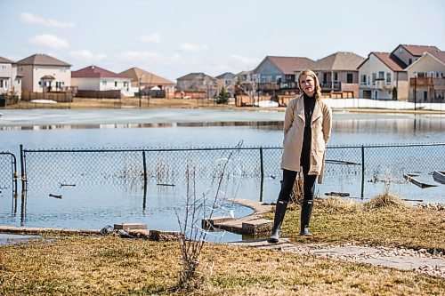 MIKAELA MACKENZIE / WINNIPEG FREE PRESS

Jennifer Lim poses for a portrait in her yard, which is partially flooded by an overflowing retention pond, in Winnipeg on Tuesday, May 3, 2022. For Chris Kitching story.
Winnipeg Free Press 2022.