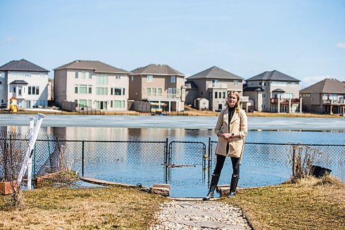 MIKAELA MACKENZIE / WINNIPEG FREE PRESS

Jennifer Lim poses for a portrait in her yard, which is partially flooded by an overflowing retention pond, in Winnipeg on Tuesday, May 3, 2022. For Chris Kitching story.
Winnipeg Free Press 2022.