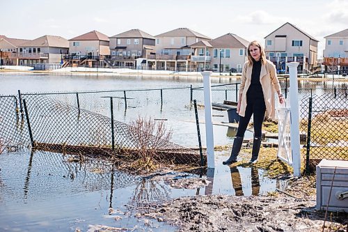 MIKAELA MACKENZIE / WINNIPEG FREE PRESS

Jennifer Lim poses for a portrait in her yard, which is partially flooded by an overflowing retention pond, in Winnipeg on Tuesday, May 3, 2022. For Chris Kitching story.
Winnipeg Free Press 2022.