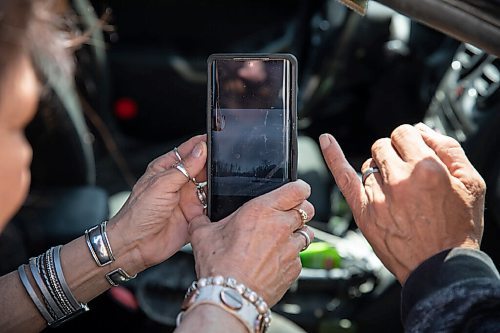 JESSICA LEE / WINNIPEG FREE PRESS

Peguis flood evacuees Christopher Sinclair (right) and Arlene Spence show on their phone a video of the flood in their town on May 3, 2022 at the Westin Hotel.They were given a place to stay in Gimli but drove down to the Westin to check up on family who were staying there.

Reporter: Erik Pindera