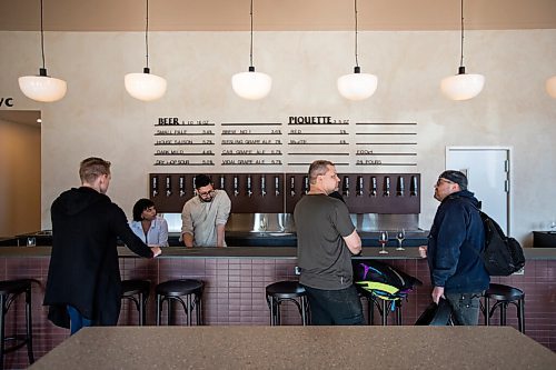 Daniel Crump / Winnipeg Free Press. Patrons gather at the bar to order drinks and chat on opening day of Low Life Barrel House in Winnipeg. May 4, 2022.