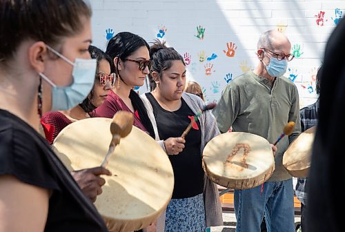 JESSICA LEE / WINNIPEG FREE PRESS

Monique Desjarlais (second from right) beats a drum and joins community members as they sing healing songs at North End Womens Centre on May 5, 2022 for Red Dress Day. 

