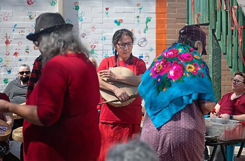 JESSICA LEE / WINNIPEG FREE PRESS

Hilda Mann (centre) is photographed at North End Womens Centre on May 5, 2022 for Red Dress Day. Community members gathered to sing healing songs for the afternoon.

