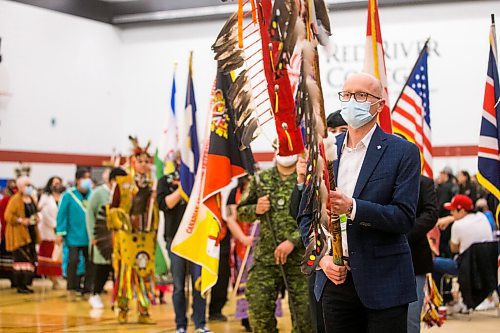 MIKAELA MACKENZIE / WINNIPEG FREE PRESS

RRC Polytech president Fred Meier leads the flag ceremony during a graduation Pow Wow in Winnipeg on Friday, May 6, 2022. For Malak Abas story.
Winnipeg Free Press 2022.