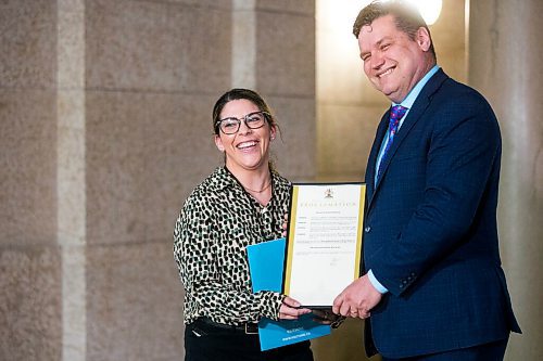 MIKAELA MACKENZIE / WINNIPEG FREE PRESS

Dr. Megan Hebert, clinical psychologist at KidThink Childrens Mental Health Centre Inc (left), and James Teitsma, MLA for Radisson, hold the proclamation announcing Child and Youth Mental Health Day at the Manitoba Legislative Building in Winnipeg on Friday, May 6, 2022. For Katie May story.
Winnipeg Free Press 2022.