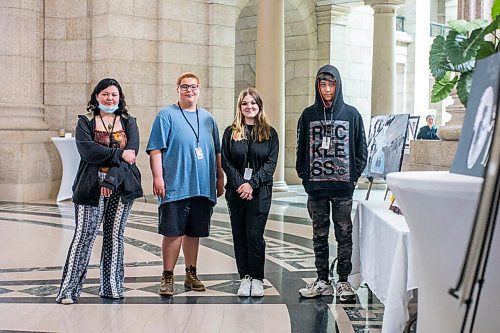 MIKAELA MACKENZIE / WINNIPEG FREE PRESS

Argyle Alternative High School students Ricki-Lynn Crain (left), Ethan McInnes, Maia Kasian, and Tyler Boyle pose for a portrait by their art displayed at an announcement of Child and Youth Mental Health Day at the Manitoba Legislative Building in Winnipeg on Friday, May 6, 2022. For Katie May story.
Winnipeg Free Press 2022.