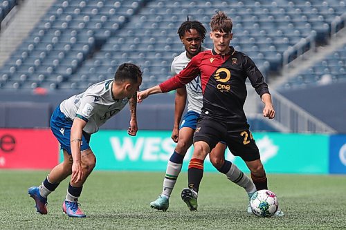 Daniel Crump / Winnipeg Free Press. Valour FC Sean Rea (24) holds off a Halifax Wanderers player during Valours home opener at IG Field in Winnipeg. May 7, 2022.