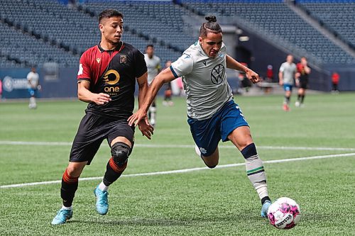 Daniel Crump / Winnipeg Free Press. Halifax Wanderers  Zachary Fernandez (3) and a Valour FC player race for the ball during Valours home opener at IG Field in Winnipeg. May 7, 2022.