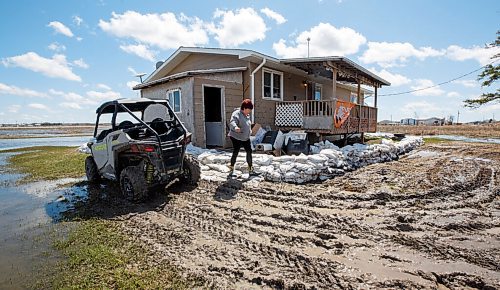 MIKE DEAL / WINNIPEG FREE PRESS
Bertha Therrien outside her home in Peguis First Nation. The flood water was unto the top of the sandbags a couple days ago.
Residents of Peguis FN who have not fled the rising water had a small reprieve Tuesday, which has allowed them to add protection to various locations and attempt to get basements emptied of water. The forecast doesn't look good towards the end of the week with days of rain on the way.
See Malak Abas story
220510 - Tuesday, May 10, 2022.