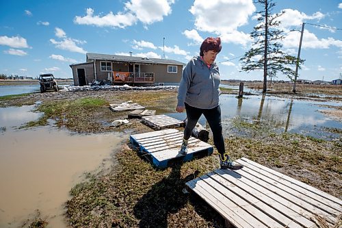 MIKE DEAL / WINNIPEG FREE PRESS
Bertha Therrien outside her home in Peguis First Nation. The flood water was unto the top of the sandbags a couple days ago.
Residents of Peguis FN who have not fled the rising water had a small reprieve Tuesday, which has allowed them to add protection to various locations and attempt to get basements emptied of water. The forecast doesn't look good towards the end of the week with days of rain on the way.
See Malak Abas story
220510 - Tuesday, May 10, 2022.