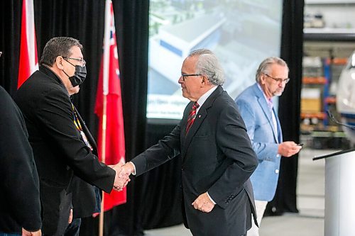 MIKAELA MACKENZIE / WINNIPEG FREE PRESS

Chief David Monias (left) shakes hands with Gary Filmon after the announcement of the new Gary Filmon Indigenous Terminal at the Exchange Income Corp. annual meeting in the Calm Air hangar in Winnipeg on Wednesday, May 11, 2022. For Martin Cash story.
Winnipeg Free Press 2022.